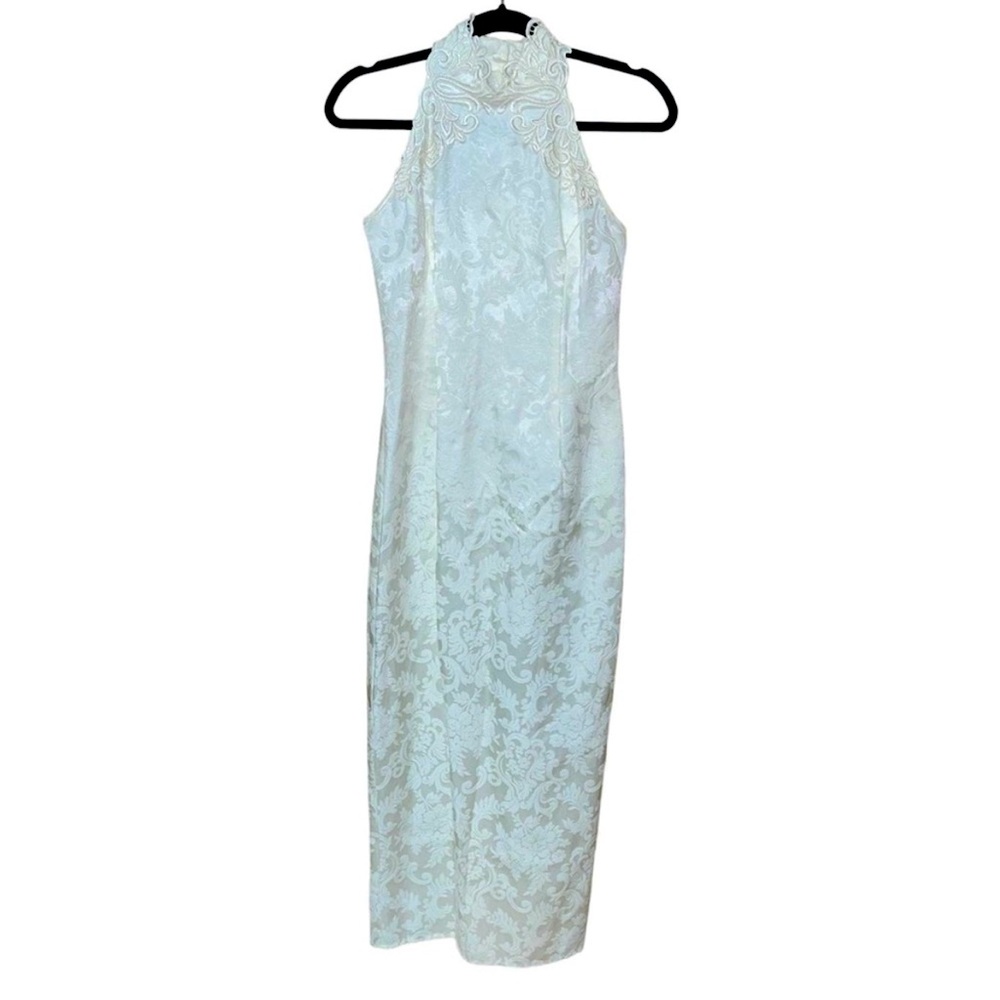 The dress is ivory and beautiful. Size 6 with. Gorgeous neckline.